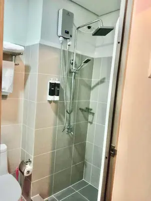 a bathroom with a shower with a glass door at La Chicka Staycation in Coast Residences in Manila