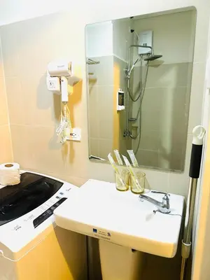a bathroom with a sink and a mirror at La Chicka Staycation in Coast Residences in Manila