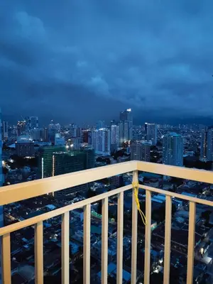 a view of a city skyline at night at La Chicka Staycation in Coast Residences in Manila
