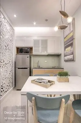 a kitchen with a table and some chairs in it at Cozy in Manila