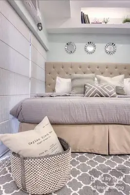 a bedroom with a large bed with a large headboard at Cozy in Manila