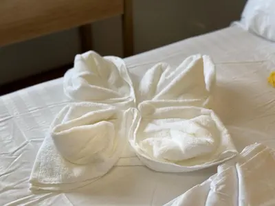 two white towels on top of a white bed at Deluxe Room with Parking in Red Residences Chino Roces Ave, Makati by Prime Stay in Manila