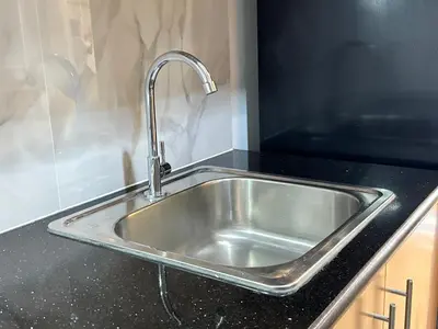 a kitchen sink with a faucet on a counter at Deluxe Room with Parking in Red Residences Chino Roces Ave, Makati by Prime Stay in Manila