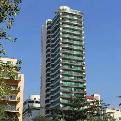 a tall building with many windows in a city at Sea View Condo in Manila