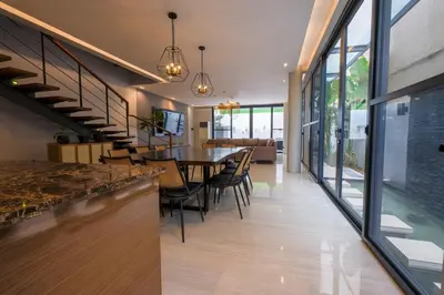 a dining room and kitchen with a table and chairs at Casa Bonifacio by JC in Manila