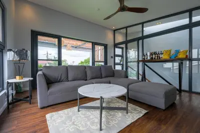 a living room with a couch and a table at Casa Bonifacio by JC in Manila