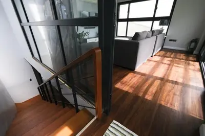 a living room with a staircase and a couch at Casa Bonifacio by JC in Manila