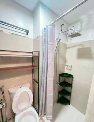 a bathroom with a toilet and a shower at La Deza Shore 2 Residences Pasay Manila in Manila