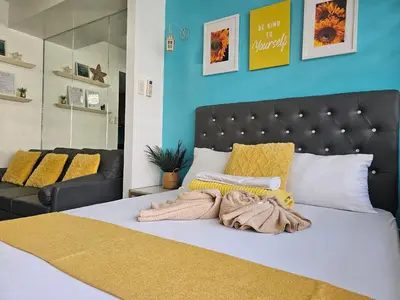 a bedroom with a bed with a black headboard at CondoDeal at Shell Residences Mall of Asia in Manila