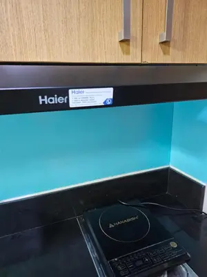 a microwave oven with a remote control on top of it at CondoDeal at Shell Residences Mall of Asia in Manila