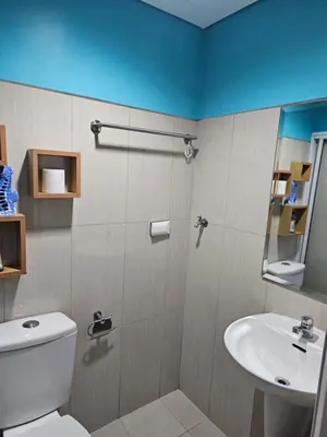 a bathroom with a toilet and a sink at CondoDeal at Shell Residences Mall of Asia in Manila