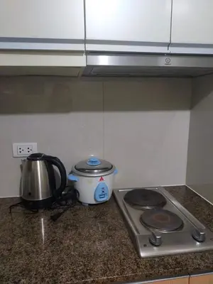 a kitchen counter with a tea pot and a tea kettle at Nadzcondotel 2- at Two Palm Tree Villas o in Manila