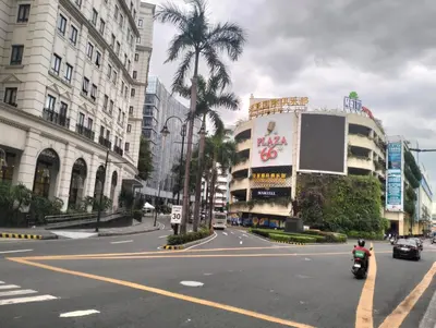 a person riding a motorcycle down a city street at Nadzcondotel 2- at Two Palm Tree Villas o in Manila