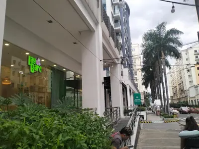 a group of people sitting outside of a building at Nadzcondotel 2- at Two Palm Tree Villas o in Manila