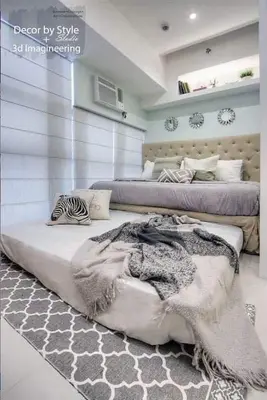 a bedroom with two beds and a rug with a blanket at Viceroy residence McKinley BGC taguig in Manila
