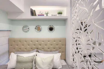 a bedroom with a bed with a headboard and some mirrors at Viceroy residence McKinley BGC taguig in Manila