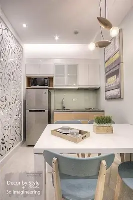 a kitchen with a table and some chairs in it at Viceroy residence McKinley BGC taguig in Manila