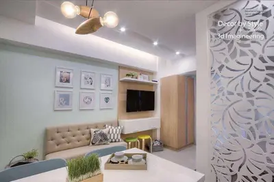 a living room with a couch and a tv at Viceroy residence McKinley BGC taguig in Manila