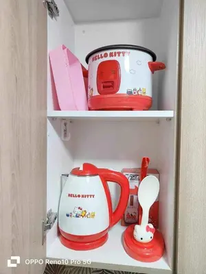 a cupboard with a tea pot and a tea kettle at MOA Exquisite Suite Manila by JAO's Staycation in Manila
