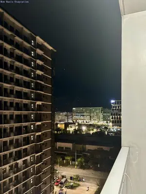 a view of a city at night from a building at New Oasis Staycation Shore 1 in Manila