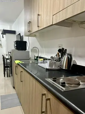 a kitchen with a sink and a counter top at New Oasis Staycation Shore 1 in Manila