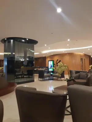 a lobby with couches and chairs and a television at Shore 2 tower 1 in Manila