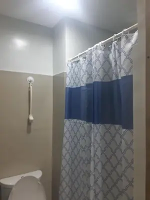 a bathroom with a shower curtain and a toilet at Shore 2 tower 1 in Manila
