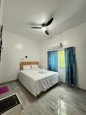 a bedroom with a bed and a ceiling fan at Shiri Hotel Pool Villa 4 \uc26c\ub9ac\ud638\ud154 \ud480\ube4c\ub77c 4 in Silang