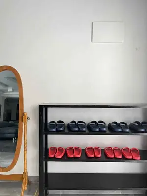 a row of shoes on a shelf next to a mirror at Shiri Hotel Pool Villa 4 \uc26c\ub9ac\ud638\ud154 \ud480\ube4c\ub77c 4 in Silang