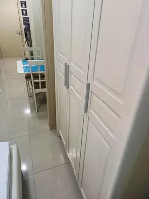 a white door in a bathroom with a hallway at Homey 1 Bedroom Condo with Blacony and Wifi in Manila