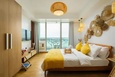 a bedroom with a bed and a large window at Azure Urban Resort Residences Parañaque City in Manila