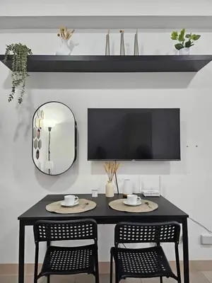 a black table with two chairs and a mirror at 642 - Quiet & secured condo in Cavite with HI speed WIFI in Dasmariñas