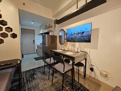 a kitchen with a table and chairs in a room at 642 - Quiet & secured condo in Cavite with HI speed WIFI in Dasmariñas