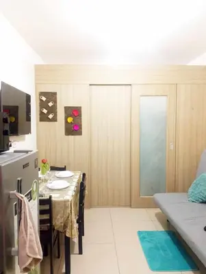 a kitchen with a table and a dining room at Shore Residences by Casa Stellar in Manila