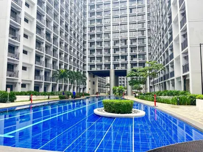 a swimming pool in the middle of a building at Shore 2 Residences by Casa Stellar mall of Asia Complex in Manila
