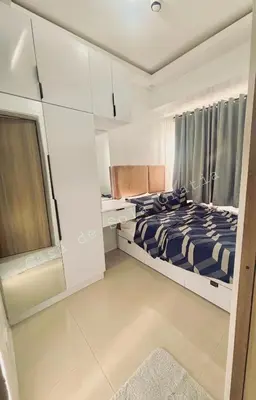 a small bedroom with a bed and a desk at Casa De Sola Gratia in Manila