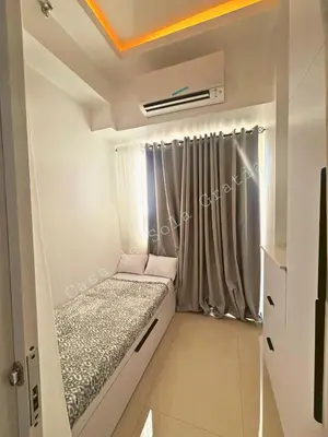 a small room with a bed and a window at Casa De Sola Gratia in Manila