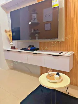 a room with a desk with a tv and a table at Casa De Sola Gratia in Manila