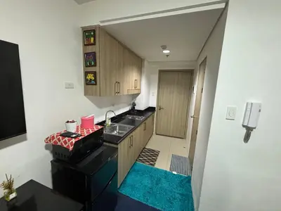 a small kitchen with a sink and a stove at MOA Home Away From Home in Manila