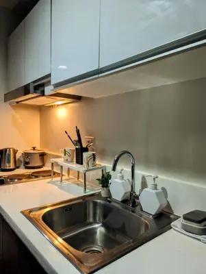 a kitchen with a sink and a counter top at Oak and Slate Oasis in Manila