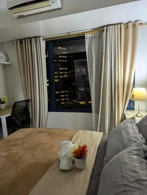 a bedroom with a bed and a window with a view at Oak and Slate Oasis in Manila