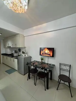 a kitchen and dining room with a table and chairs at Casa Amara Staycation in Manila