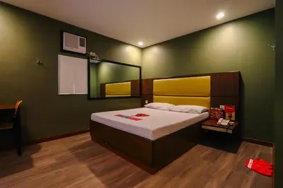 a bedroom with a large bed and a mirror at Hotel Sogo Dasmariñas Cavite in Dasmariñas