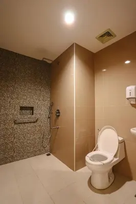 a bathroom with a toilet and a shower at Hotel Sogo Dasmariñas Cavite in Dasmariñas