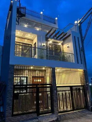 a house with a gate in front of it at night at Casa Estela in Binangonan
