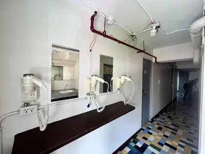 a room with three hair dryers on the wall at Junction Hostel, Poblacion Makati Avenue, Manila in Manila