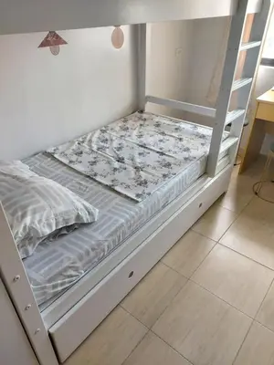 a white bunk bed with a ladder in a room at Minimalist Studio Condo - Alabang Near Airport in Manila