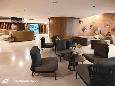 a lobby with a waiting room with chairs and tables at G Spot Manila - Mall of Asia in Manila