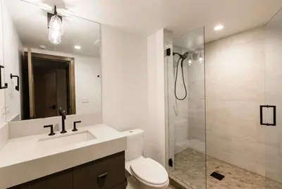 a bathroom with a shower and a toilet and a sink at 1BR Apt in Manila