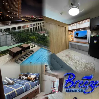 a hotel room with a swimming pool and a tv at Condo in Pasay in Manila